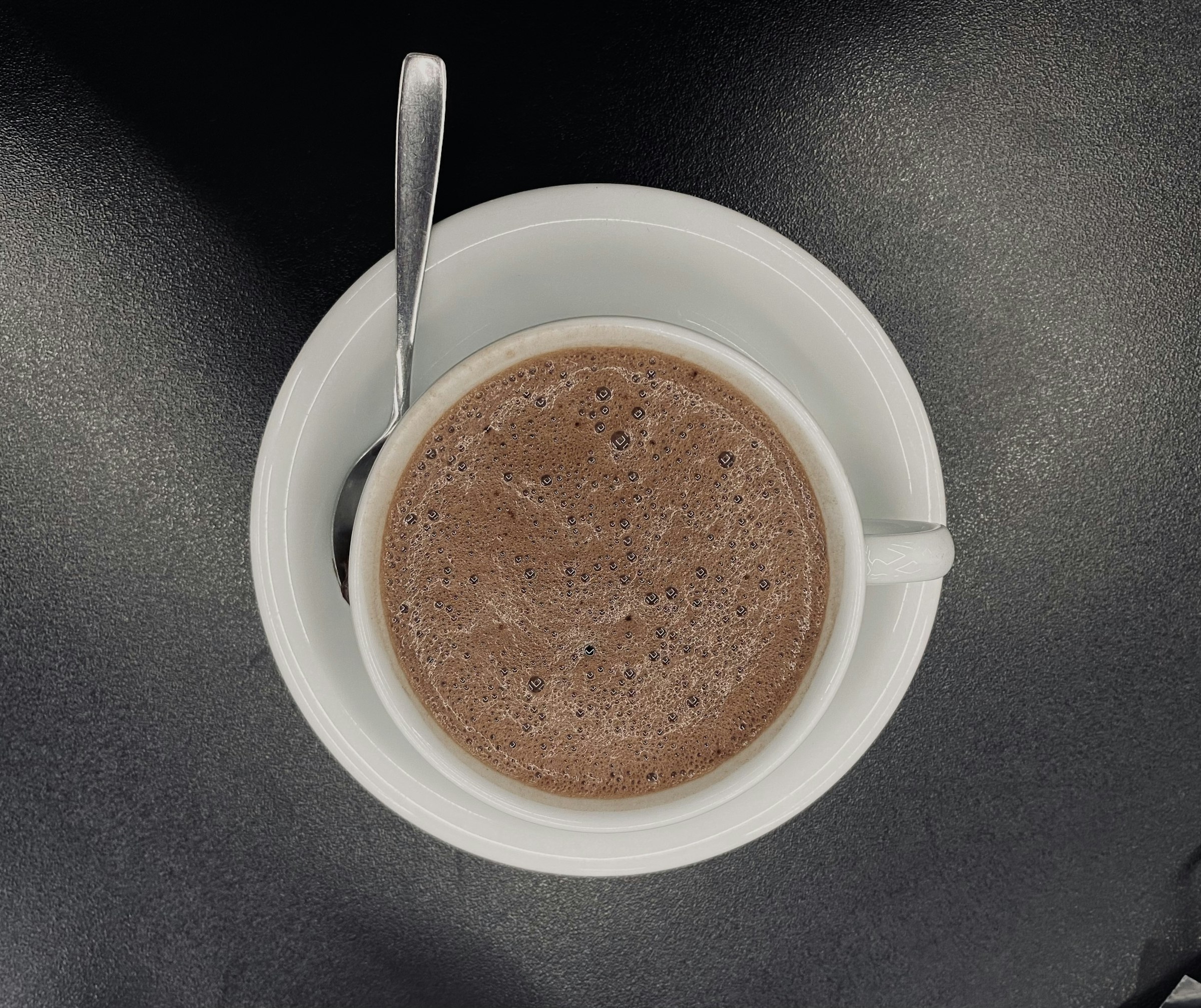 a cup of coffee with a spoon in it