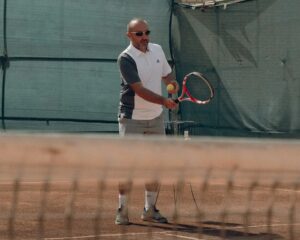 a man holding a tennis racket