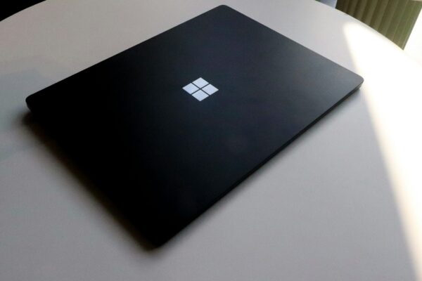 a laptop computer sitting on top of a white table