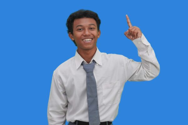 A man in a white shirt and tie pointing at the camera