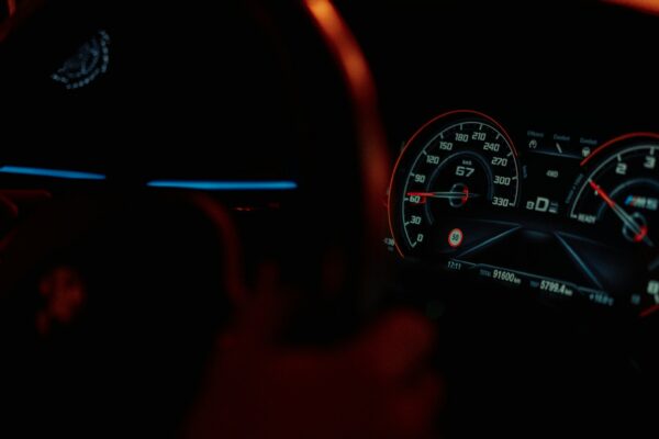the dashboard of a car in the dark
