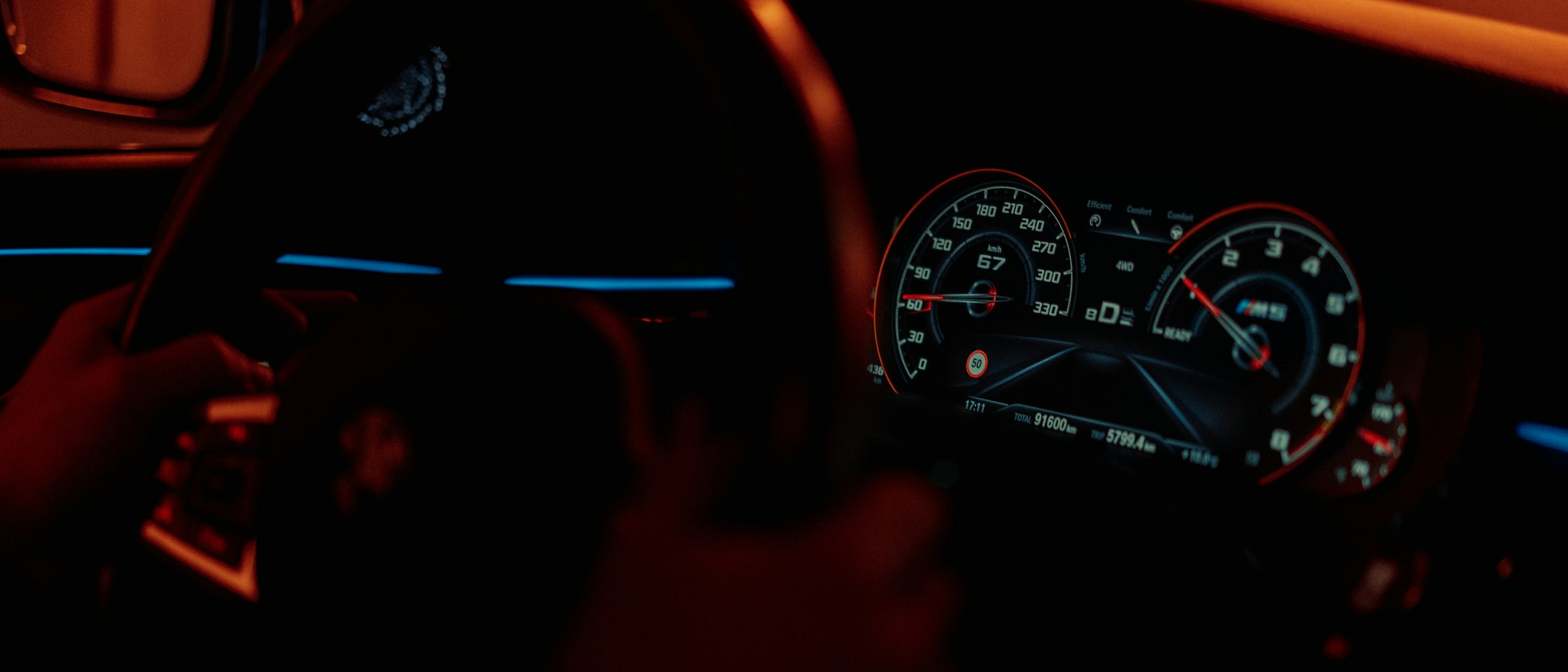 the dashboard of a car in the dark