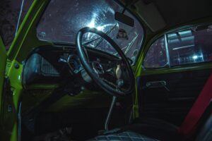 the interior of a car with a steering wheel and dashboard
