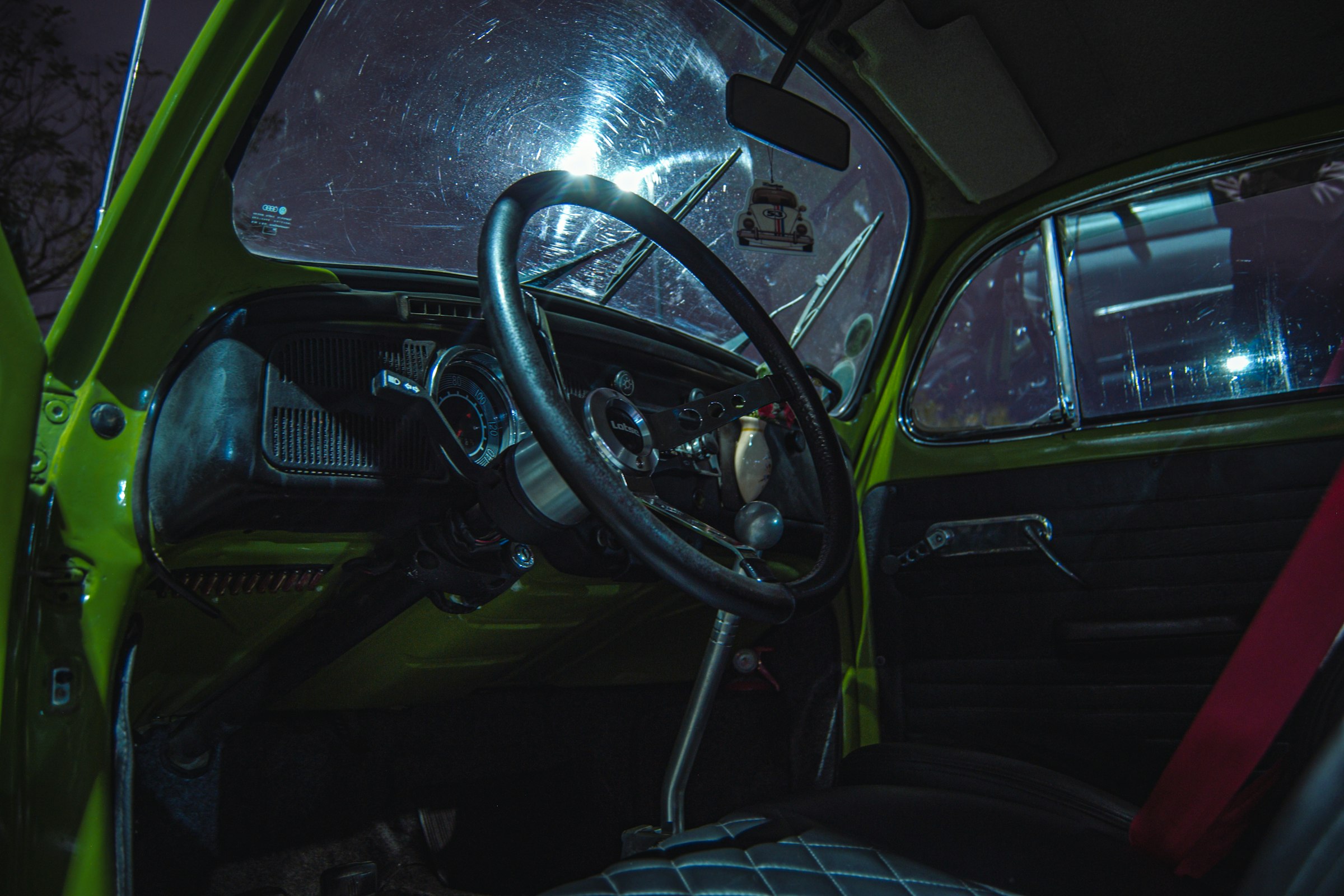 the interior of a car with a steering wheel and dashboard