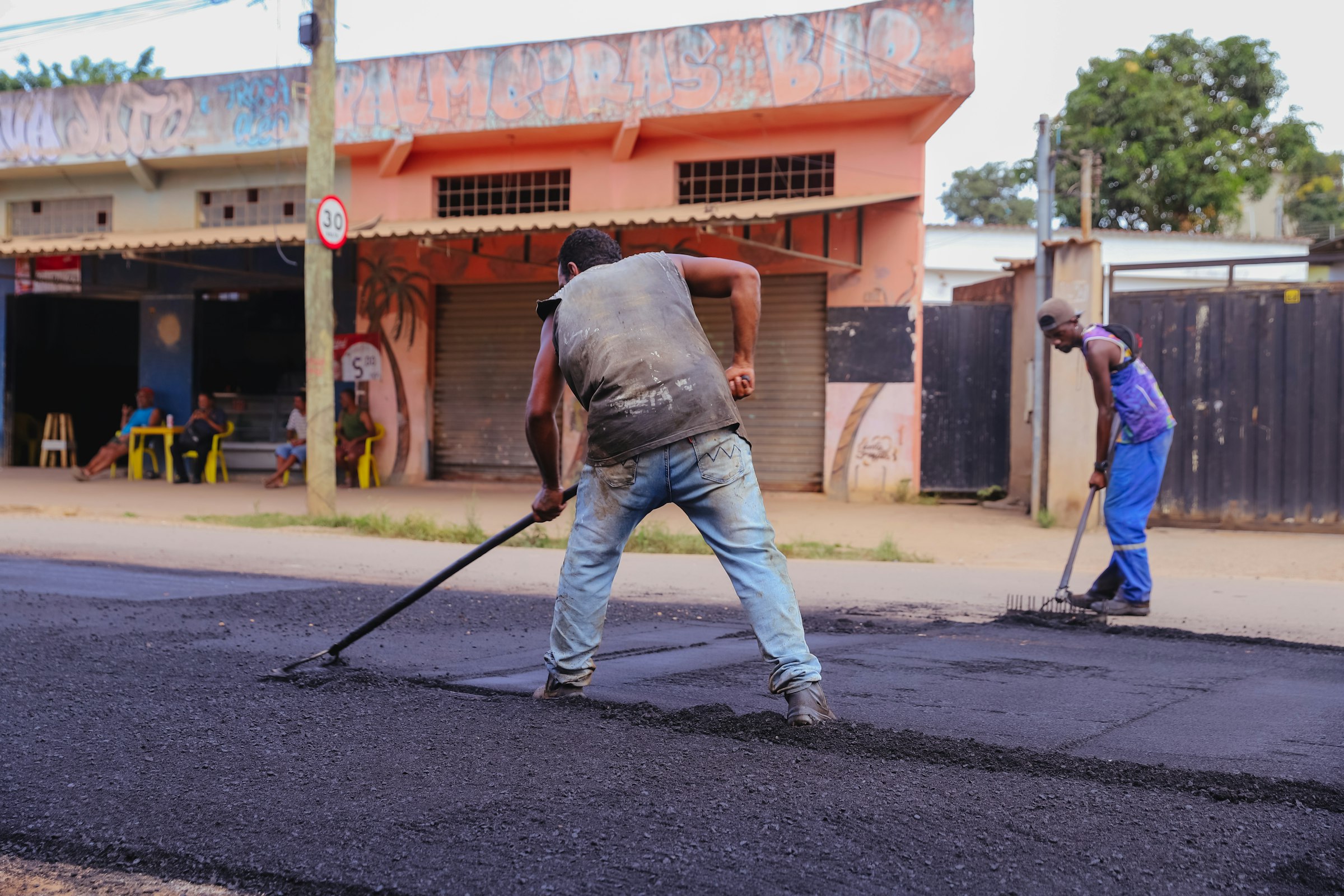 a couple of men that are standing in the street