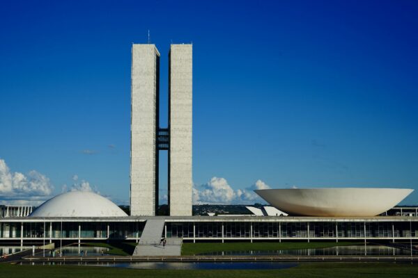 a large building with a tall tower next to a body of water