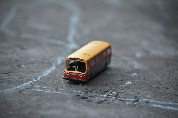 a toy bus is sitting on the ground