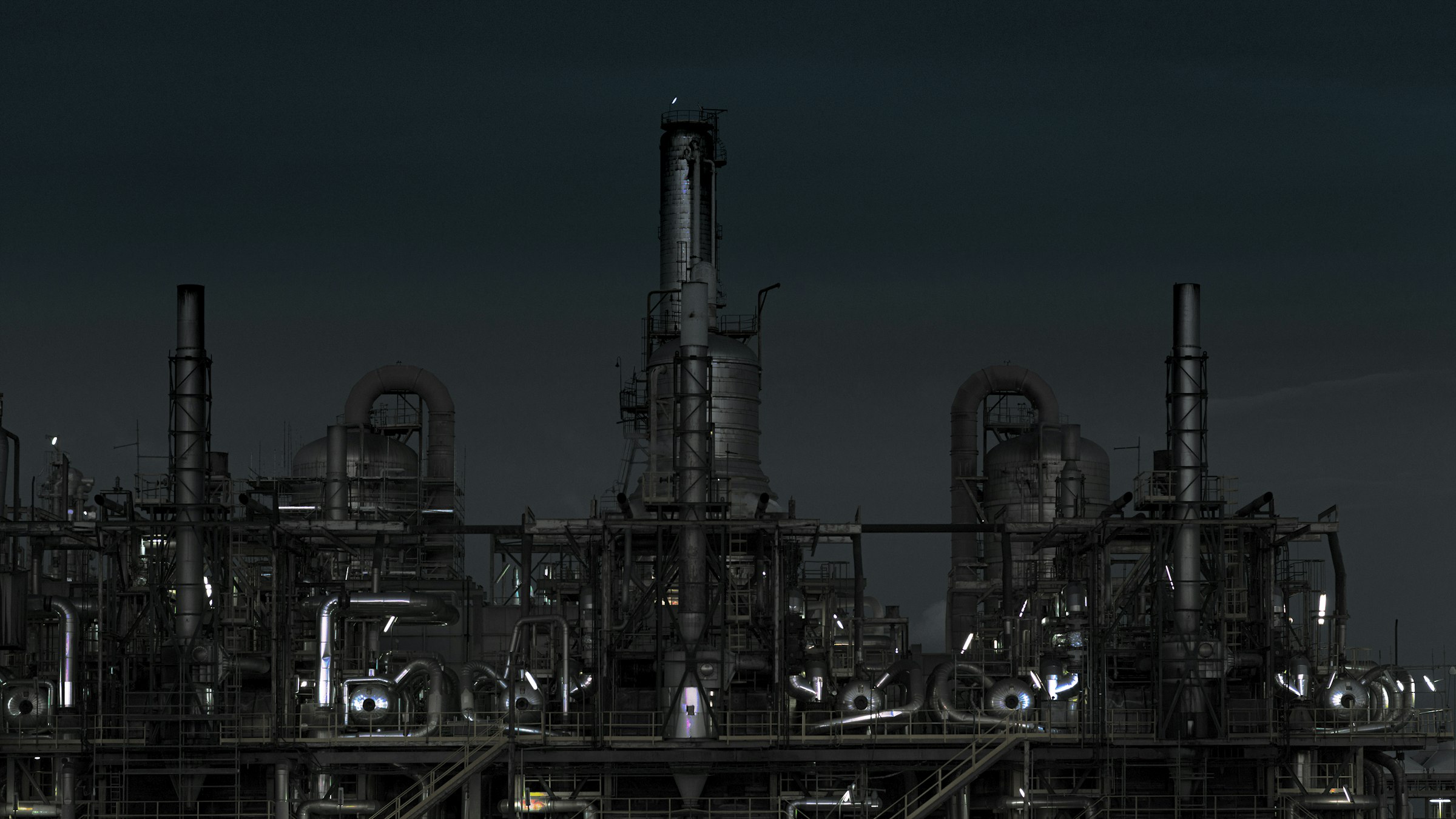 grayscale photography of factory at night