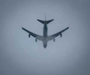 a large jetliner flying through a foggy sky