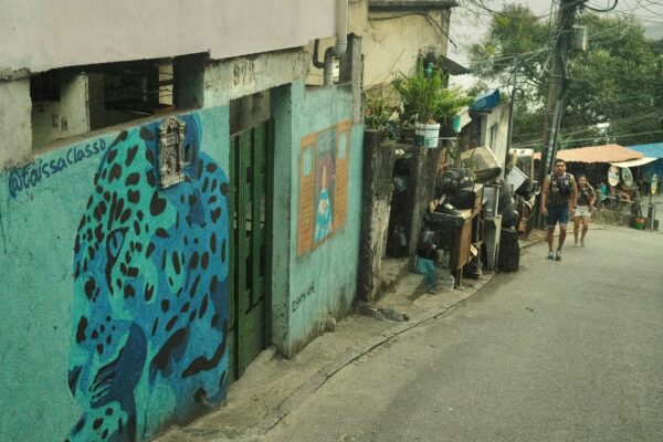 A group of people walking down a street next to a building
