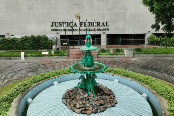 a green fountain in front of a building
