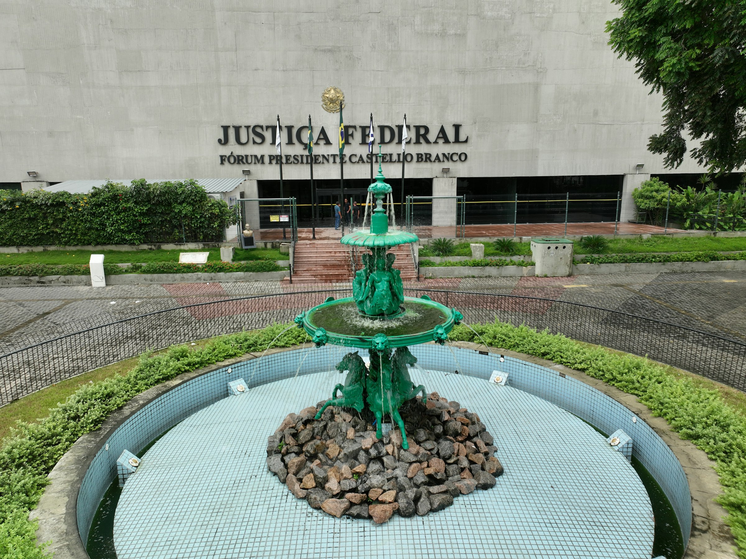 a green fountain in front of a building