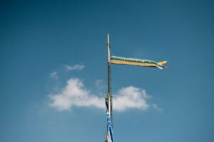 A flag pole with a flag on top of it