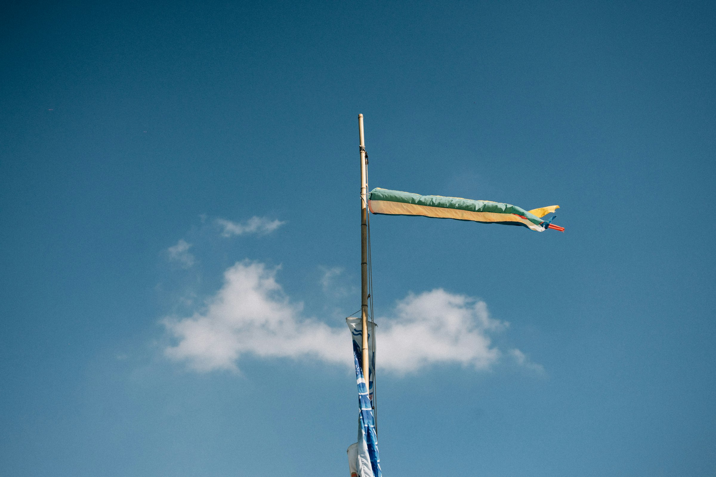 A flag pole with a flag on top of it