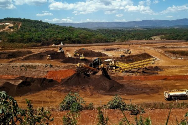 a construction site with a large amount of dirt in the foreground
