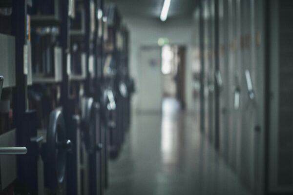 Rows of filing cabinets in a dim, long hallway.