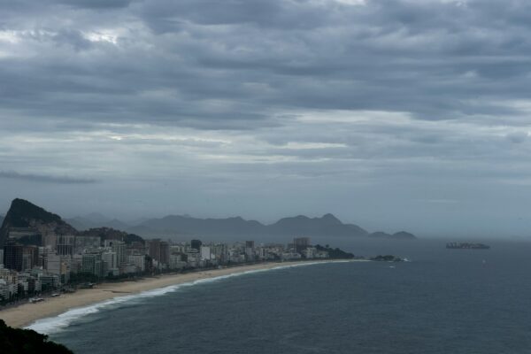 a view of a beach with a city in the distance