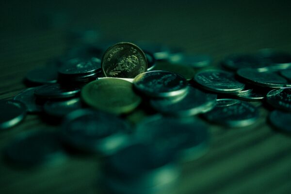 silver round coins on blue surface