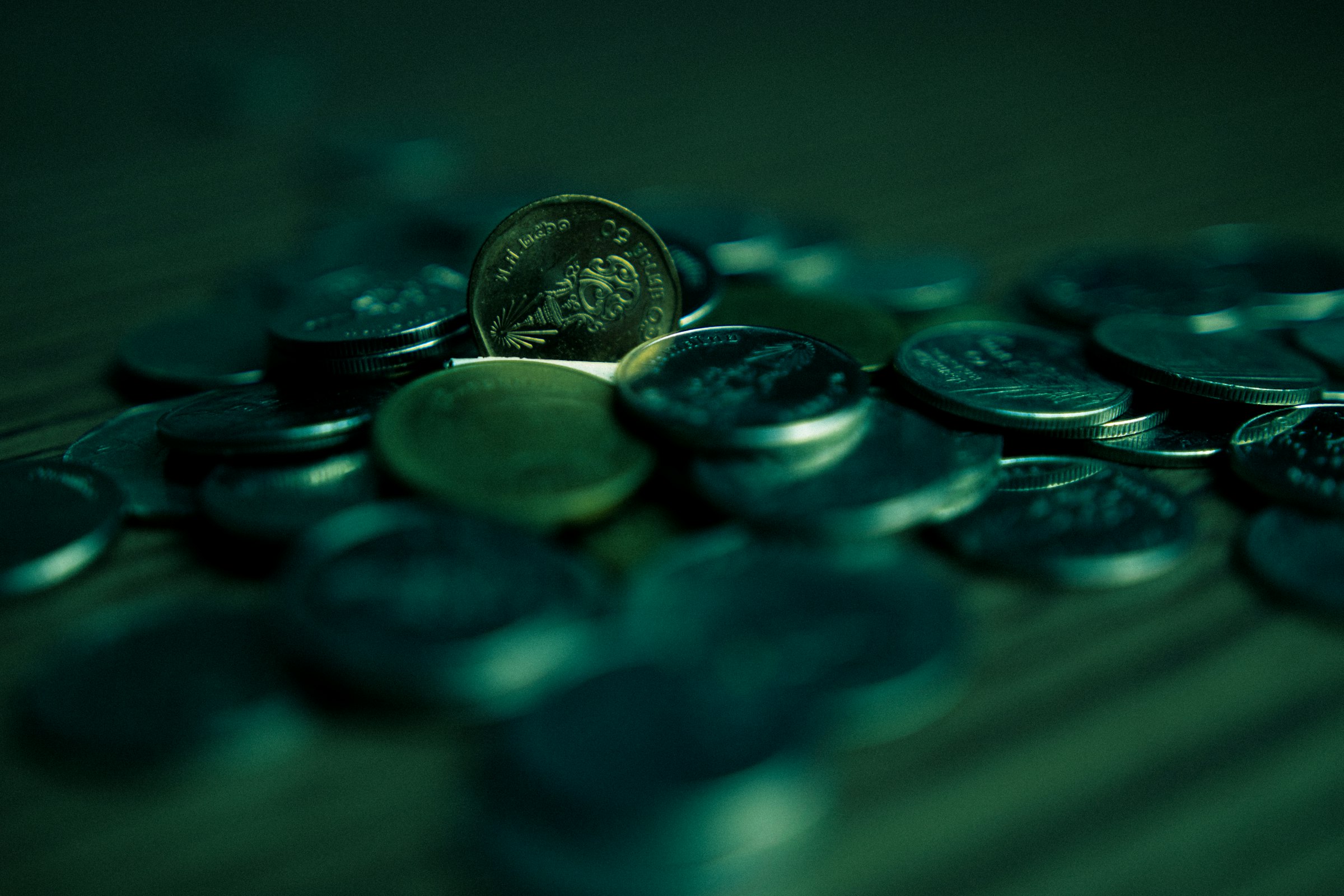 silver round coins on blue surface
