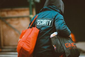 man in black and orange jacket with orange and black backpack