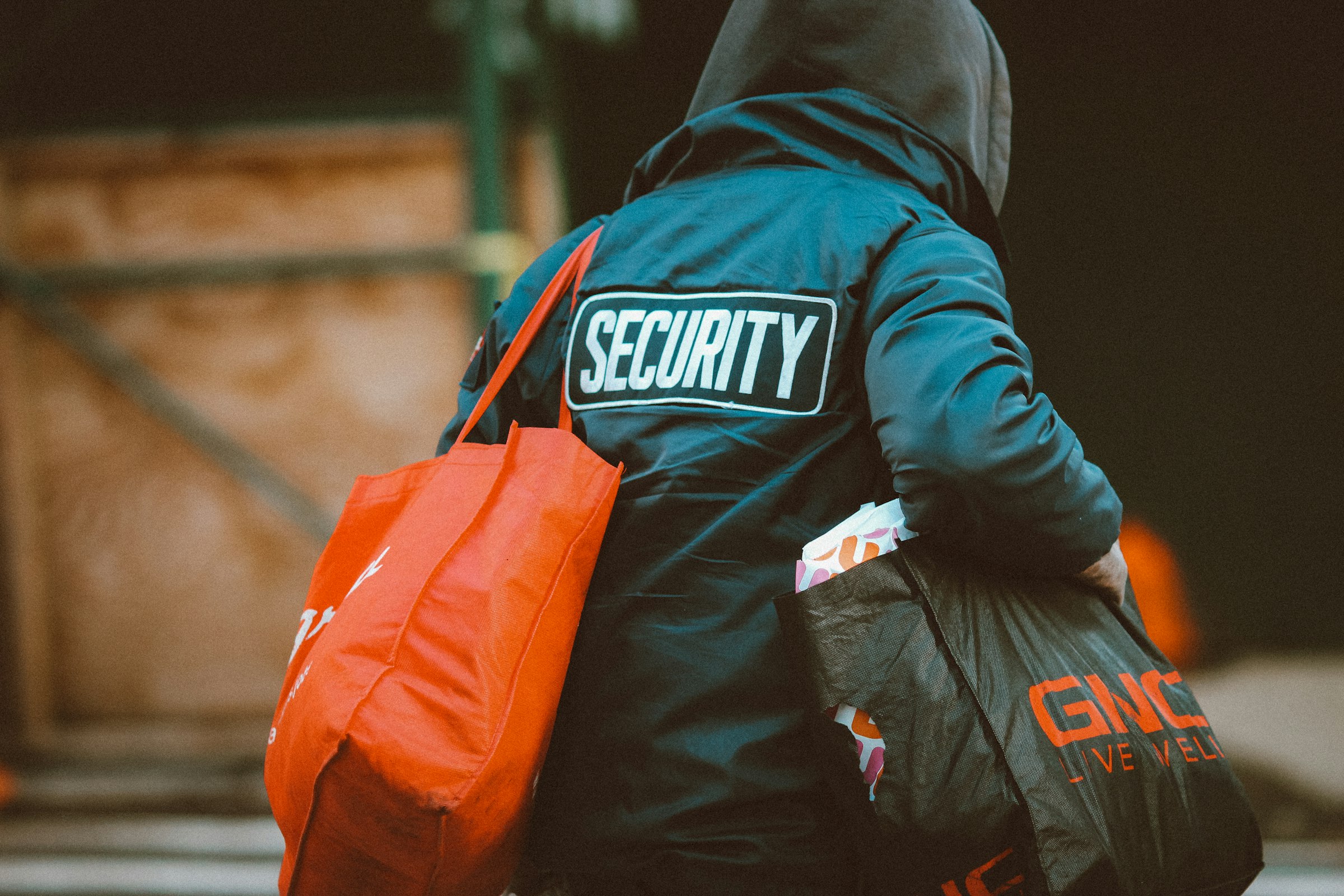 man in black and orange jacket with orange and black backpack