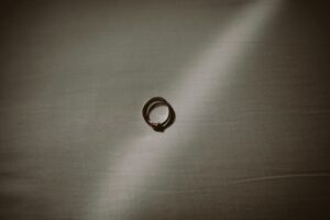 silver ring on gray textile