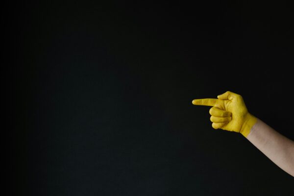 person holding up middle finger