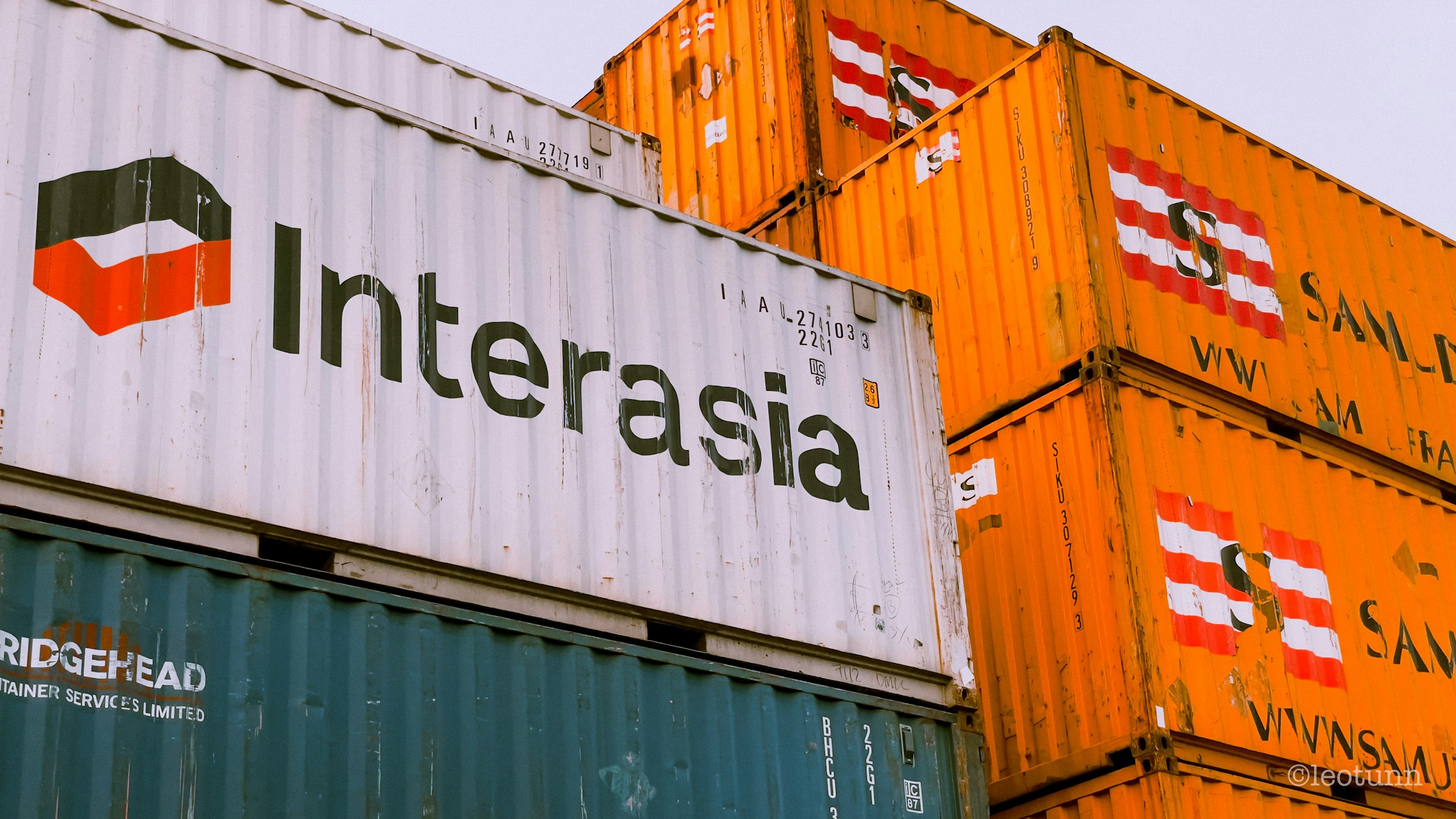 a stack of shipping containers with the word interasia on them