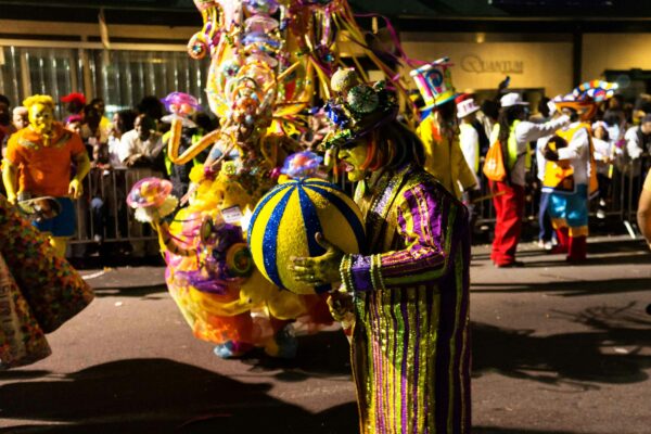 a man dressed in a colorful outfit and holding a ball