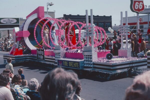 a float with a woman on it in a parade