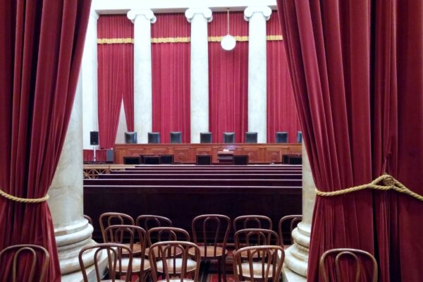 a room with red curtains and chairs in it