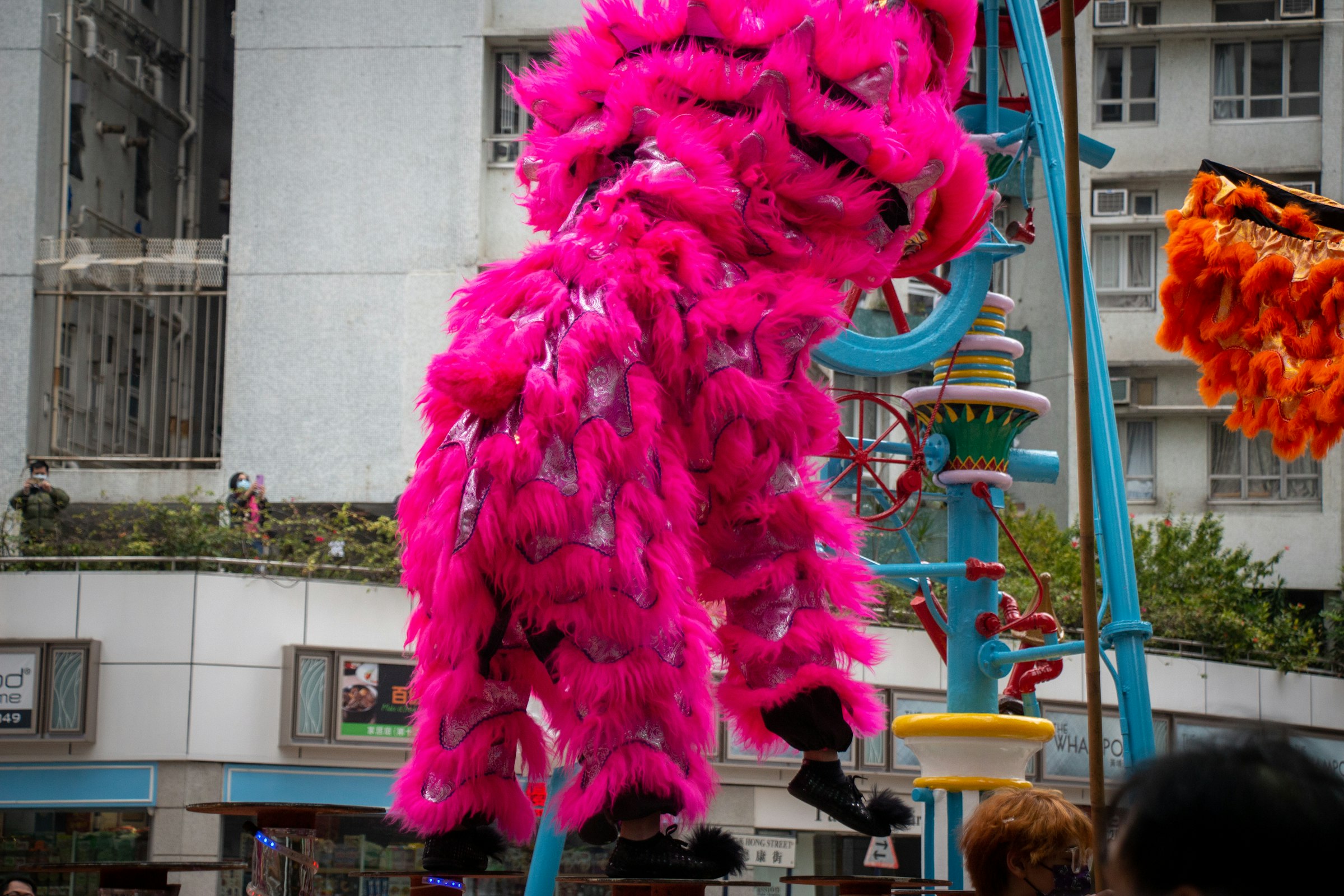 a colorful display of feathers hanging from a pole