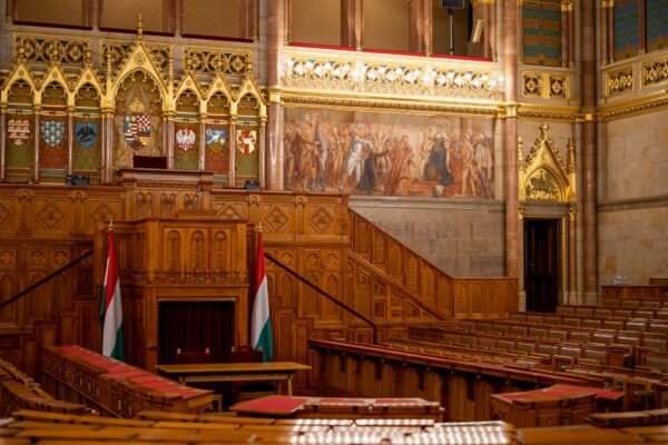 the interior of a large building with wooden pews