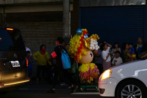 A parade float in the middle of a city street