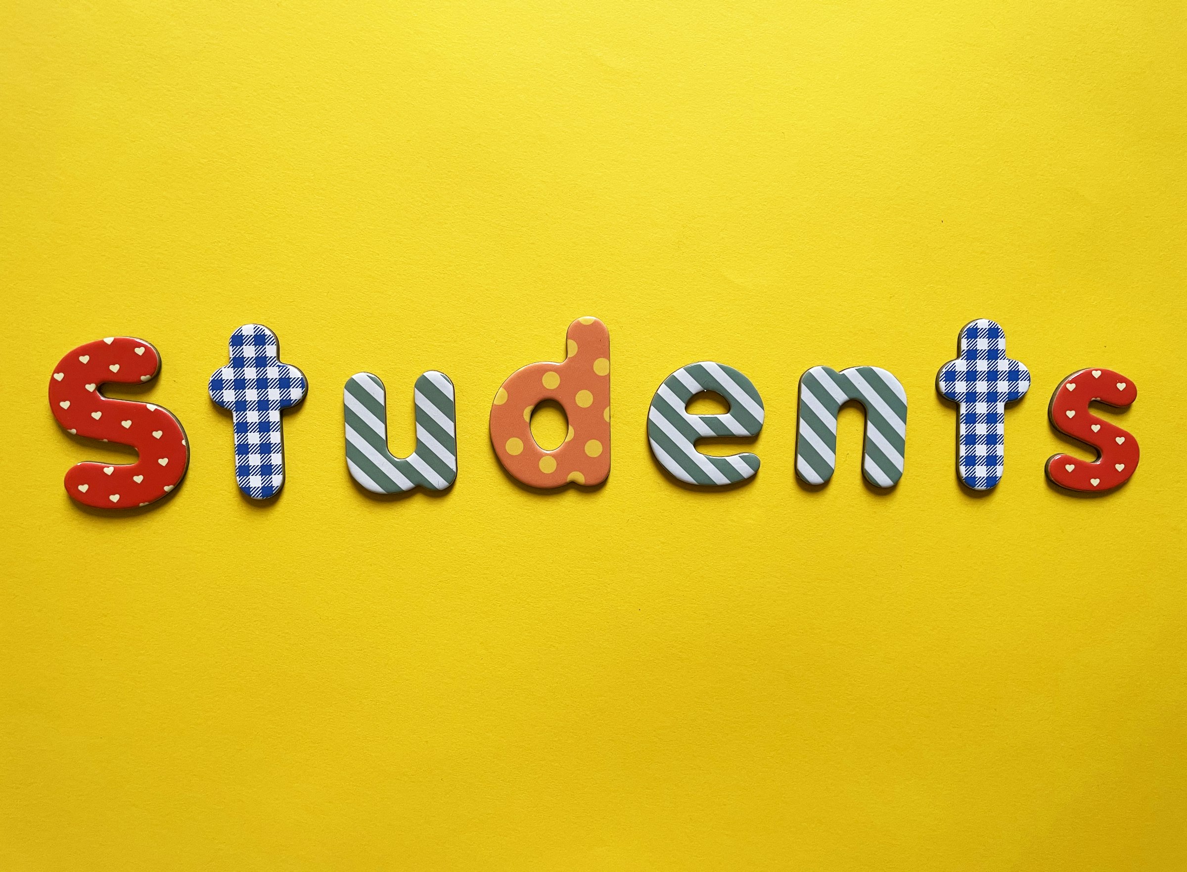 a yellow background with the word students spelled out